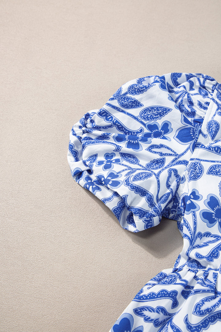 Blue and white patterned dress on a beige surface
