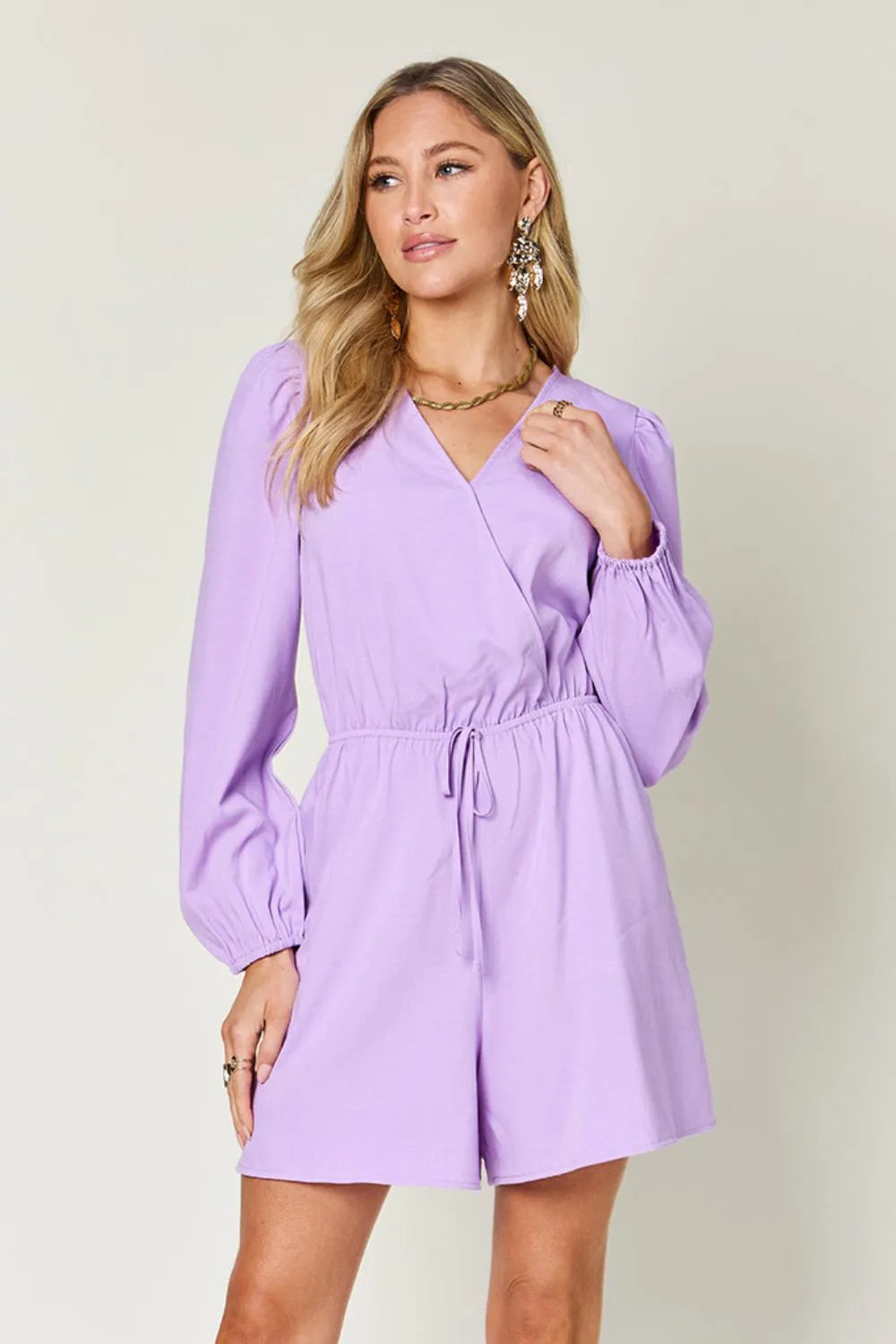 Woman wearing a purple dress against a plain background