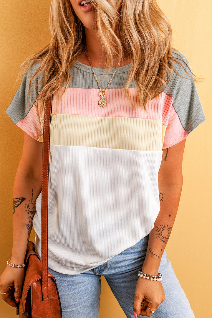 Woman wearing a colorful striped shirt with a yellow background