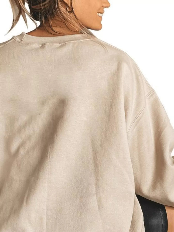 Women wearing tan sweatshirt facing the wall