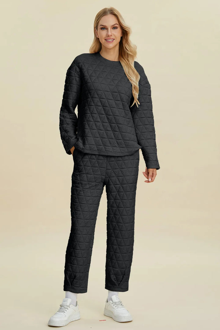 Woman wearing a black quilted outfit on a beige background
