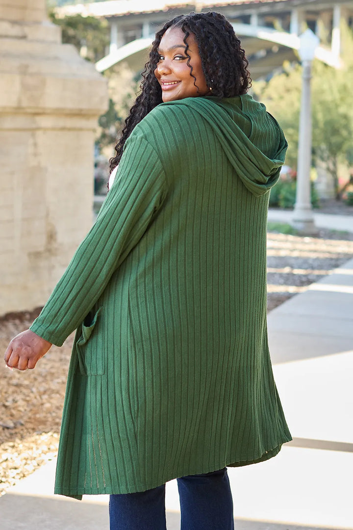Woman wearing a green sweater in an outdoor setting