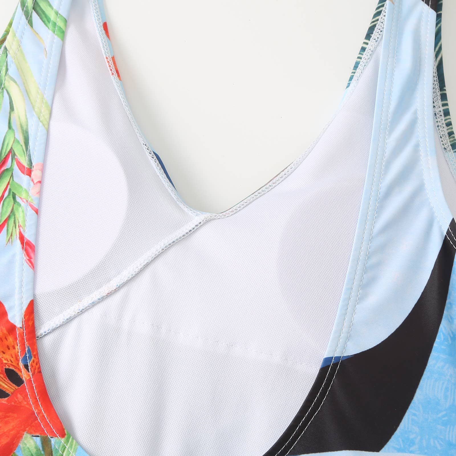 Close-up of a swimsuit with floral design on a white background