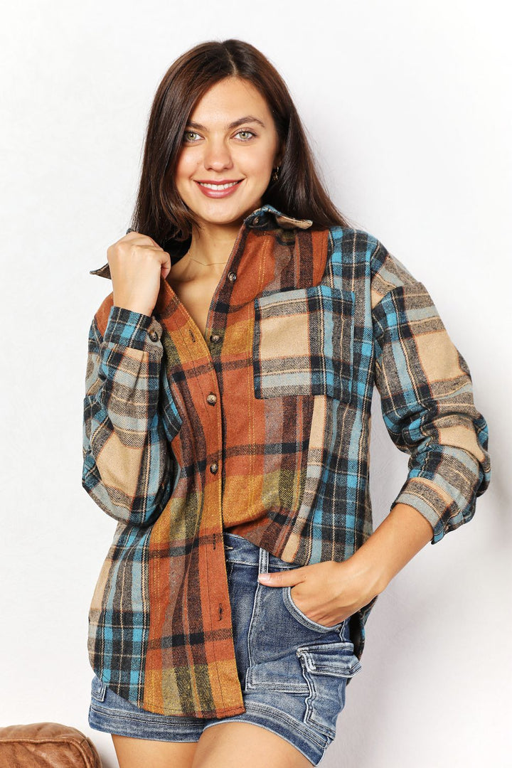 Woman wearing a plaid shirt with a white background
