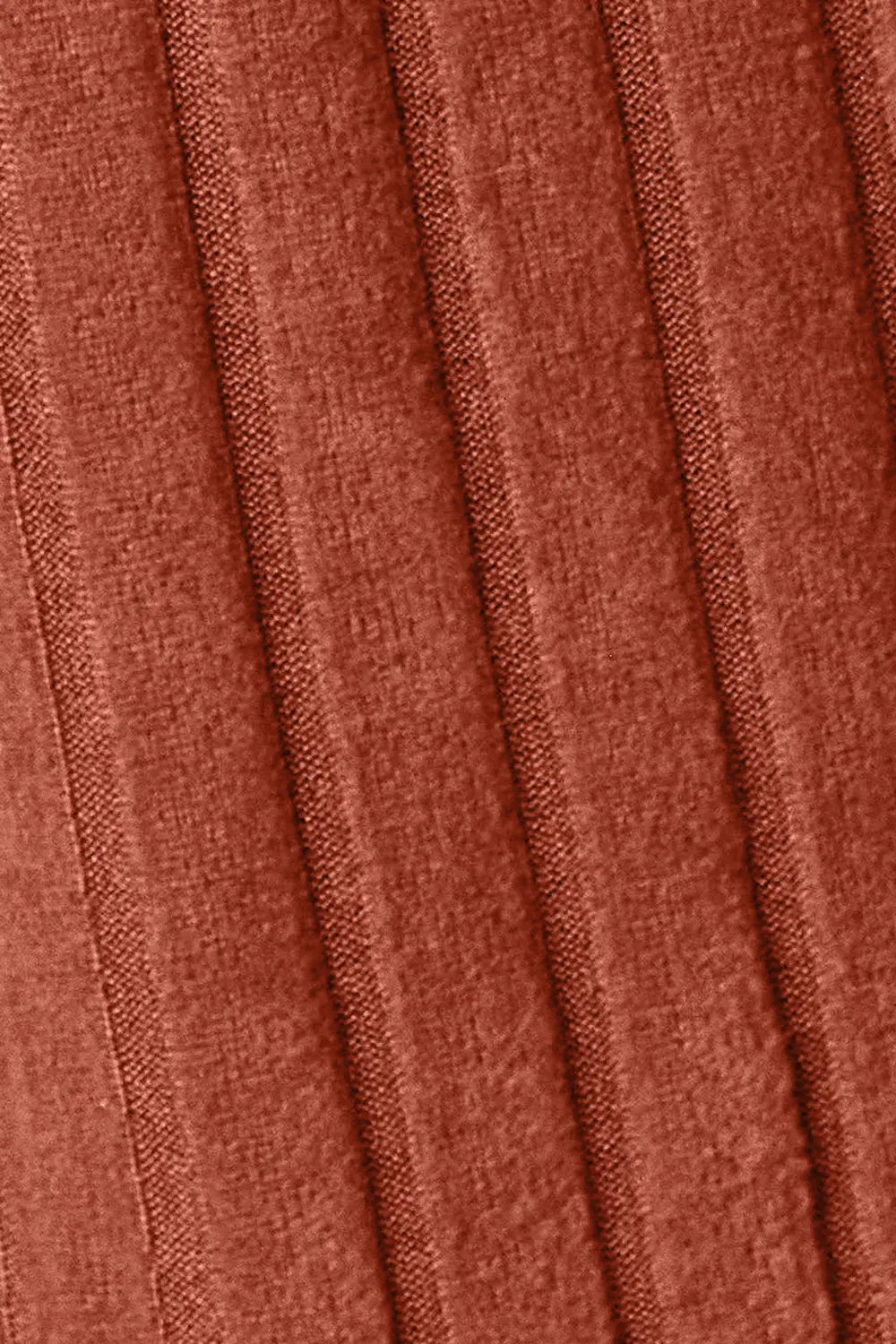 Close-up of pleated fabric with a rust-colored pattern