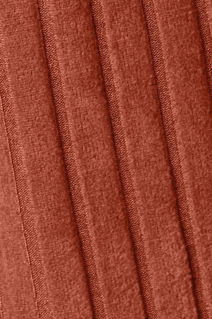 Close-up of pleated fabric with a rust-colored pattern