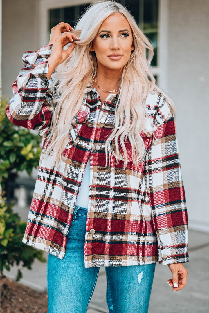 Woman wearing a plaid shirt with a blurred background