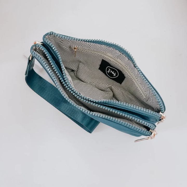 Teal wristlet opened to compartments