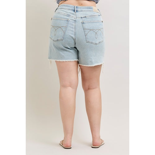Light blue denim shorts worn by a person on a plain background