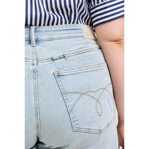 Light blue jeans with a striped shirt worn by a person