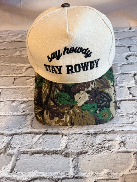 Two baseball caps with 'stay rowdy' text on a brick wall background