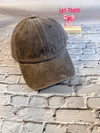 Brown baseball cap on a brick surface with 'Let Them' text in pink above.