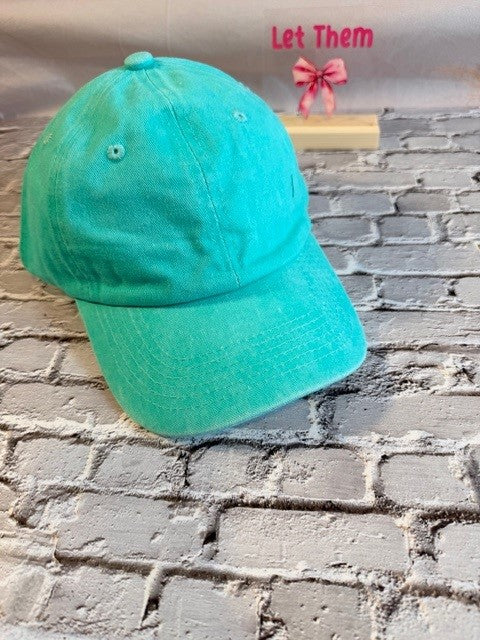 Green cap on a brick wall with text 'Let Them' above.