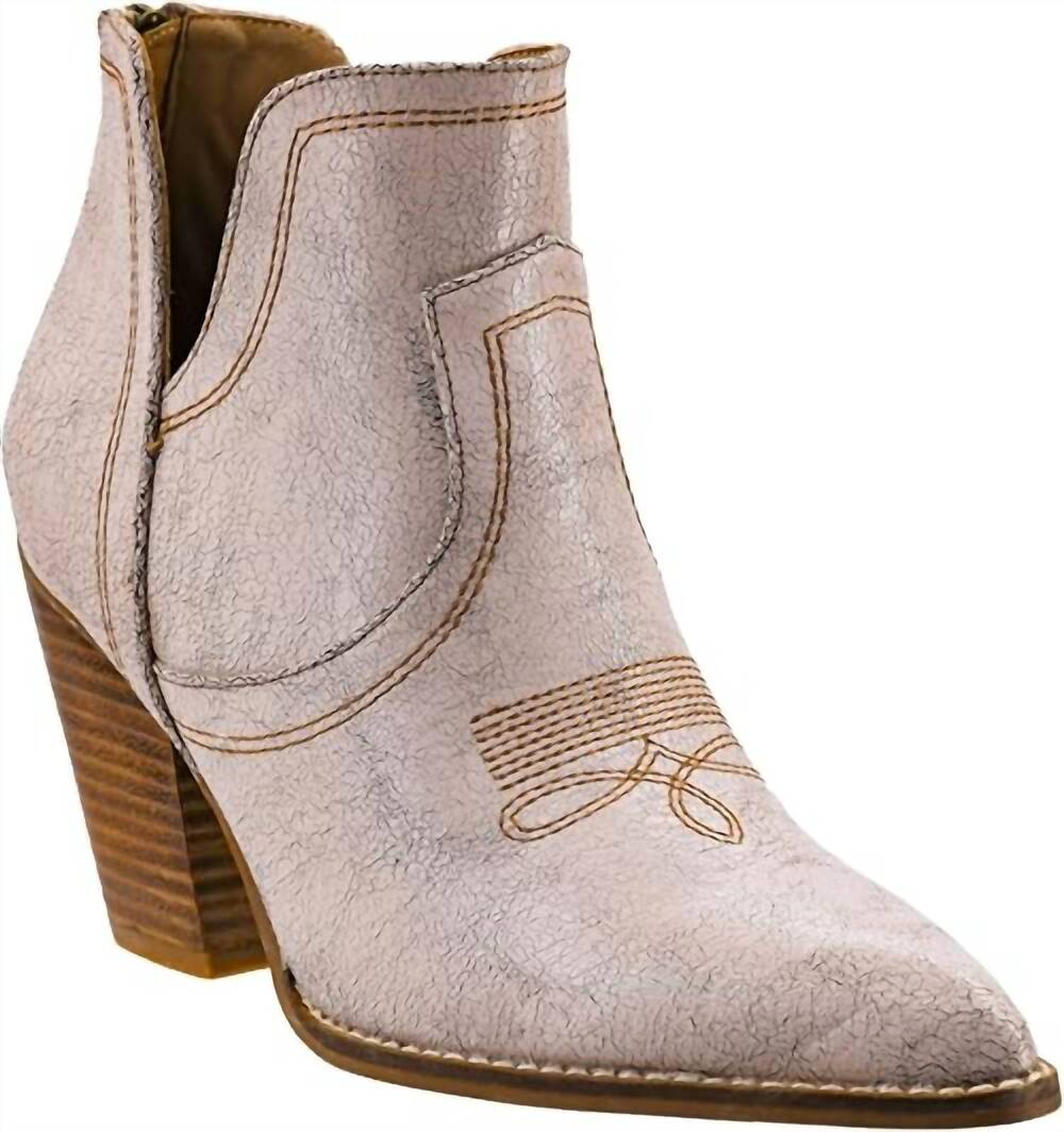 Beige ankle boot with brown heel on a white background