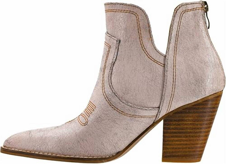A light beige textured leather ankle boot with a pointed toe, a brown wooden block heel, and a side zipper, shown against a plain white background.