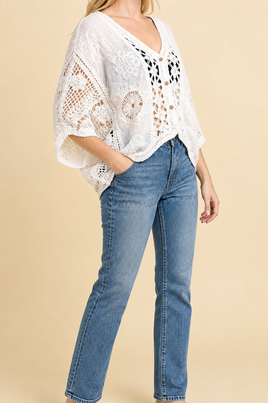 Woman wearing a floral crochet cardigan with jeans