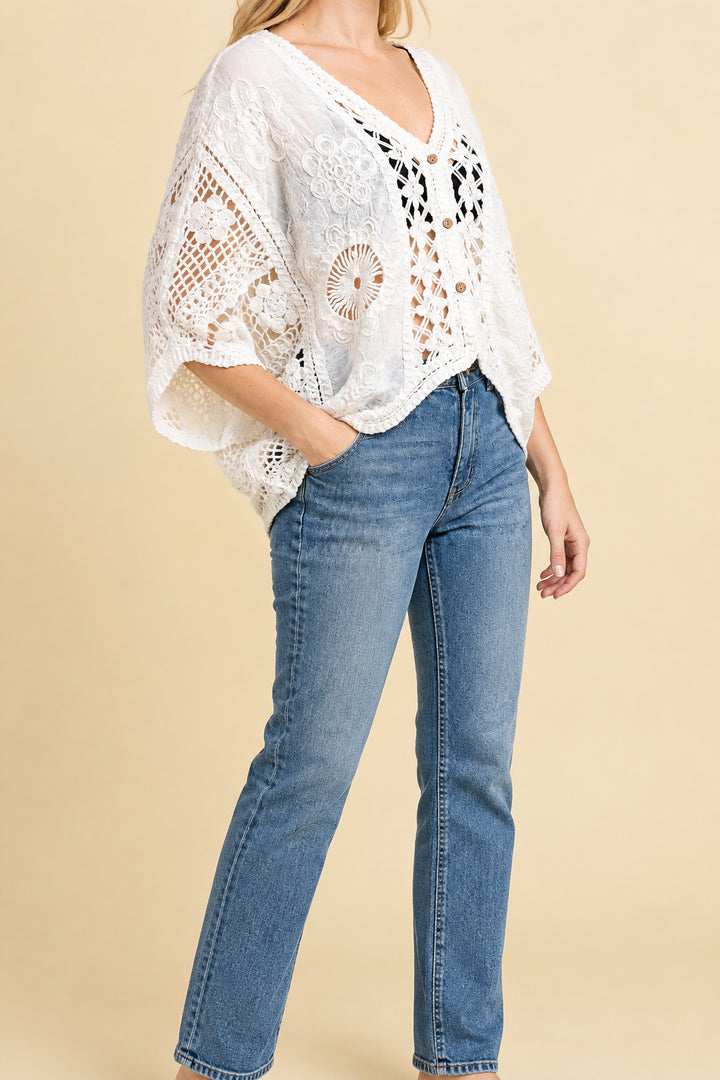 Woman wearing a floral crochet cardigan with jeans