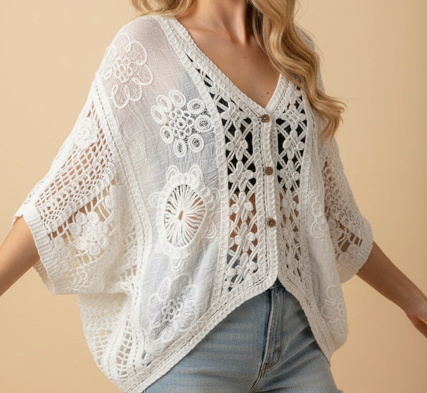 A woman wearing a crochet cardigan with jeans